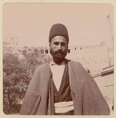 Azerbaijani man in traditional attire standing in Baku Old City in 1900