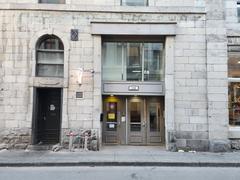 The Alternative Hostel building in Old Montreal with historic architecture and clock tower