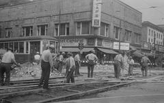 Road repair employees working with rail trams at the corner of Bleury and Sainte-Catherine Ouest in Montreal