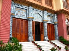 Entrance of Mohatta Palace in Karachi with intricate architecture and clear blue sky