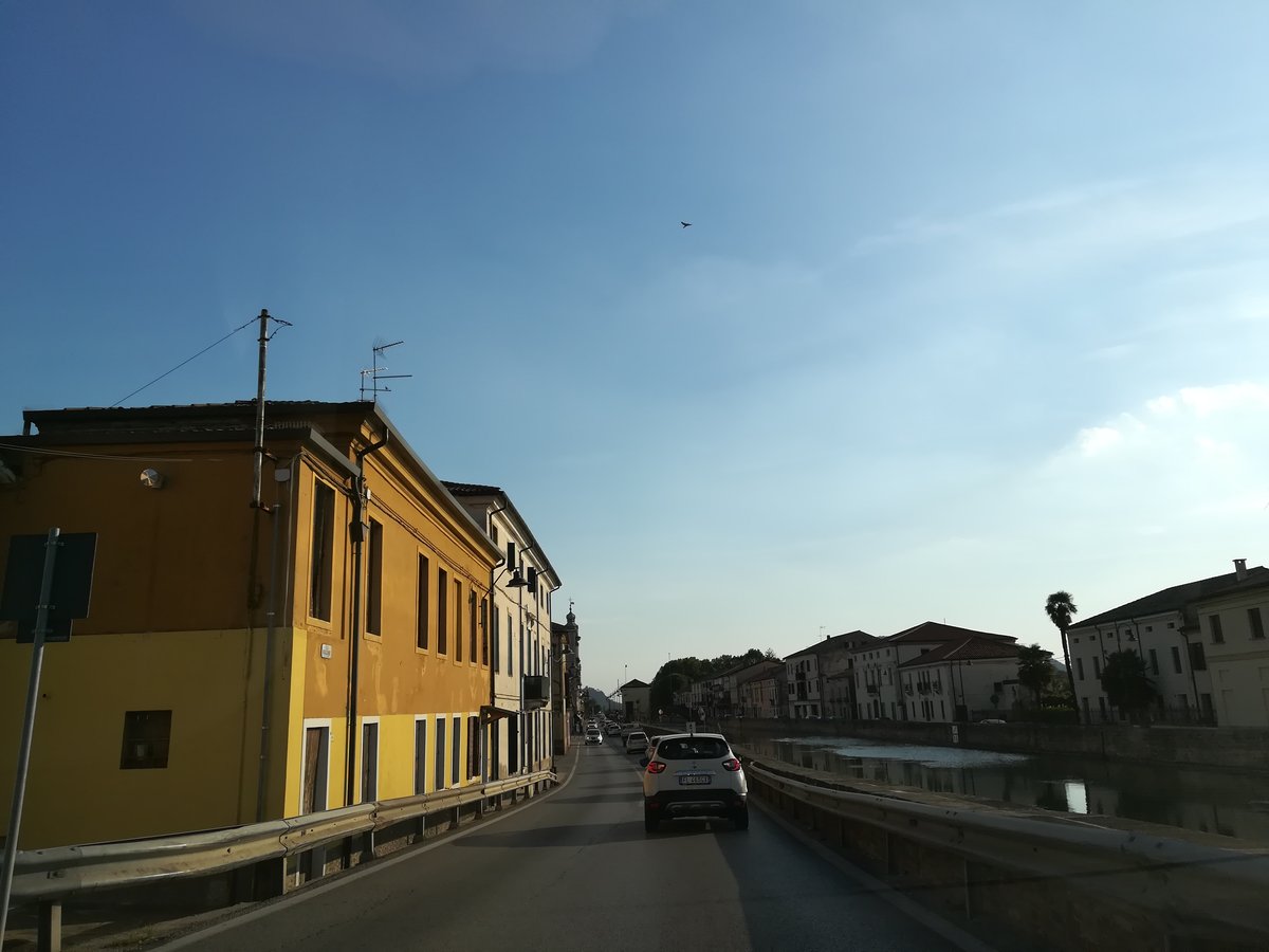 View of Battaglia Terme town with historic buildings and church tower