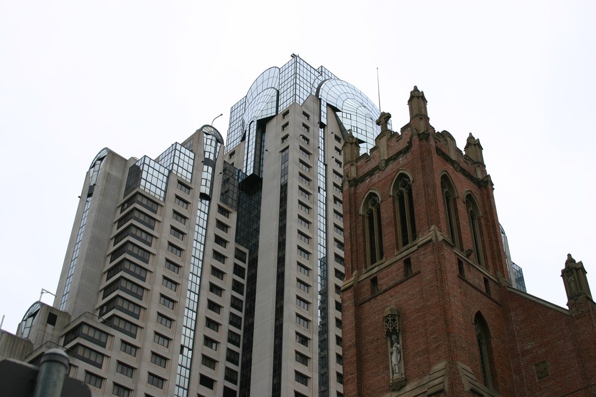 Contrast between old brick building and modern glass skyscraper