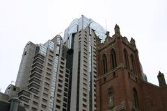 Contrast between old brick building and modern glass skyscraper