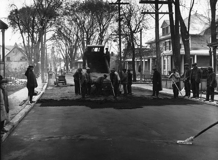 Workers spreading asphalt in Sault-aux-Récollets, Quebec around 1930