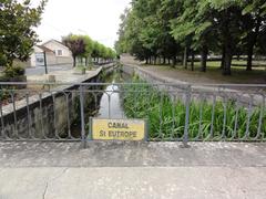 Saint-Jean-d'Angély Canal St.Eutrope in Charente-Maritime with historic buildings and calm water