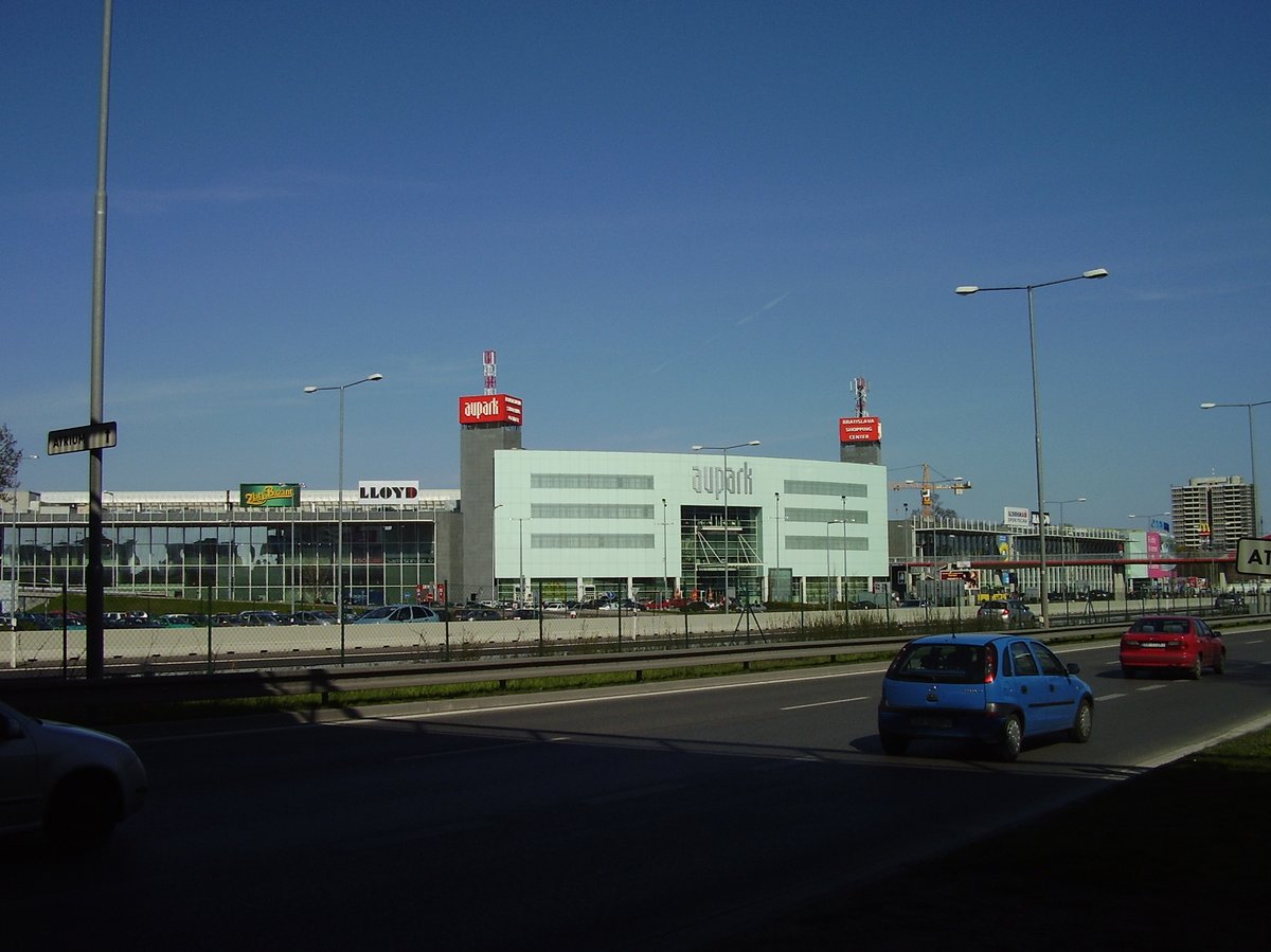 Aupark shopping mall exterior in Bratislava with a blue sky