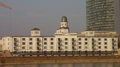 Modern waterfront development with contemporary buildings and riverfront promenade