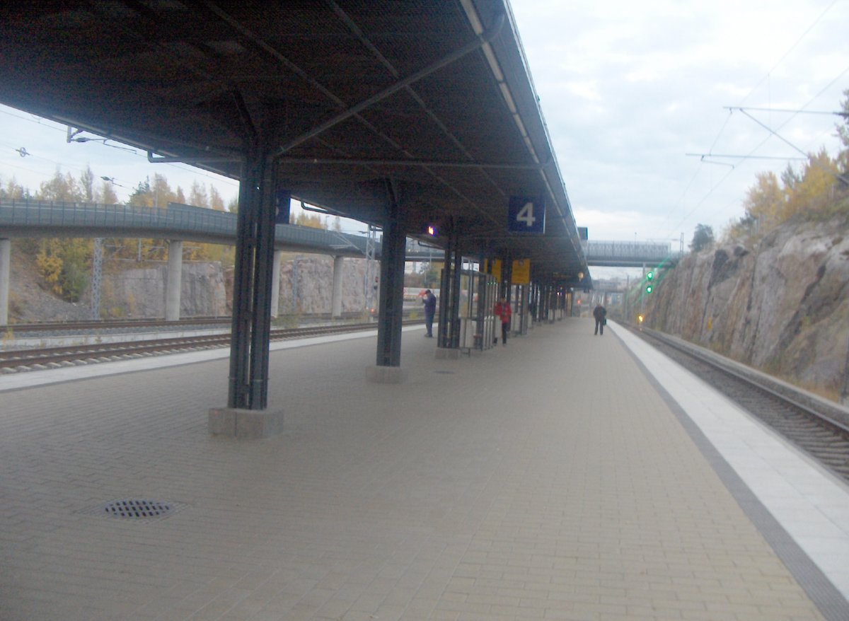Railway station platform with tracks and overhead wires in Ilmala, Helsinki