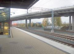 Ilmala railway station building in Helsinki with multiple train tracks and electric poles