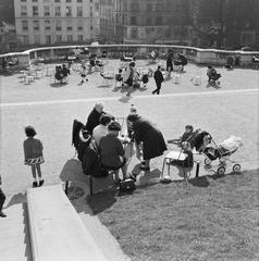 Recreation scene at the foot of the Basilique du Sacré-Coeur with people relaxing and socializing