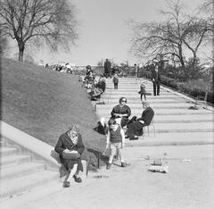 People relaxing on steps leading to the Basilique du Sacré-Cœur in Paris