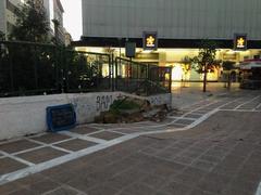 Collapsed pavement on Stadiou street in Athens revealing hollow underground area beneath