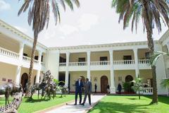 U.S. Secretary of State John Kerry and Kenyan President Uhuru Kenyatta walking across State House courtyard in Nairobi