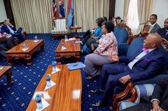 U.S. Secretary of State John Kerry joking with a staffer about his bright bow tie at State House in Nairobi, Kenya