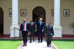 U.S. Secretary of State John Kerry walking with Kenyan President Uhuru Kenyatta outside State House Nairobi May 2015