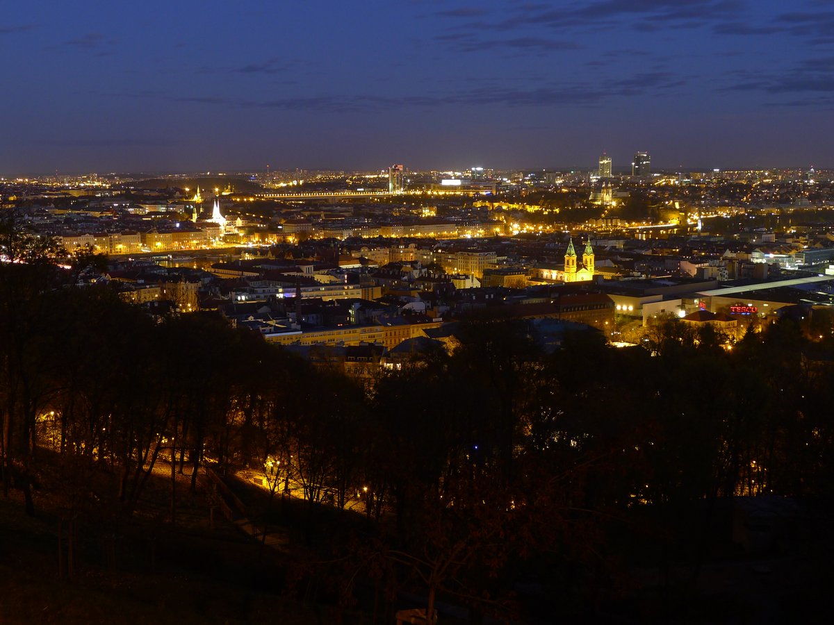 Evening view of Prague from Kinsky Garden with historic buildings and cityscape