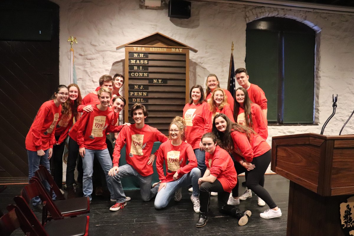 16 high school students standing by a board displaying state-by-state votes on independence
