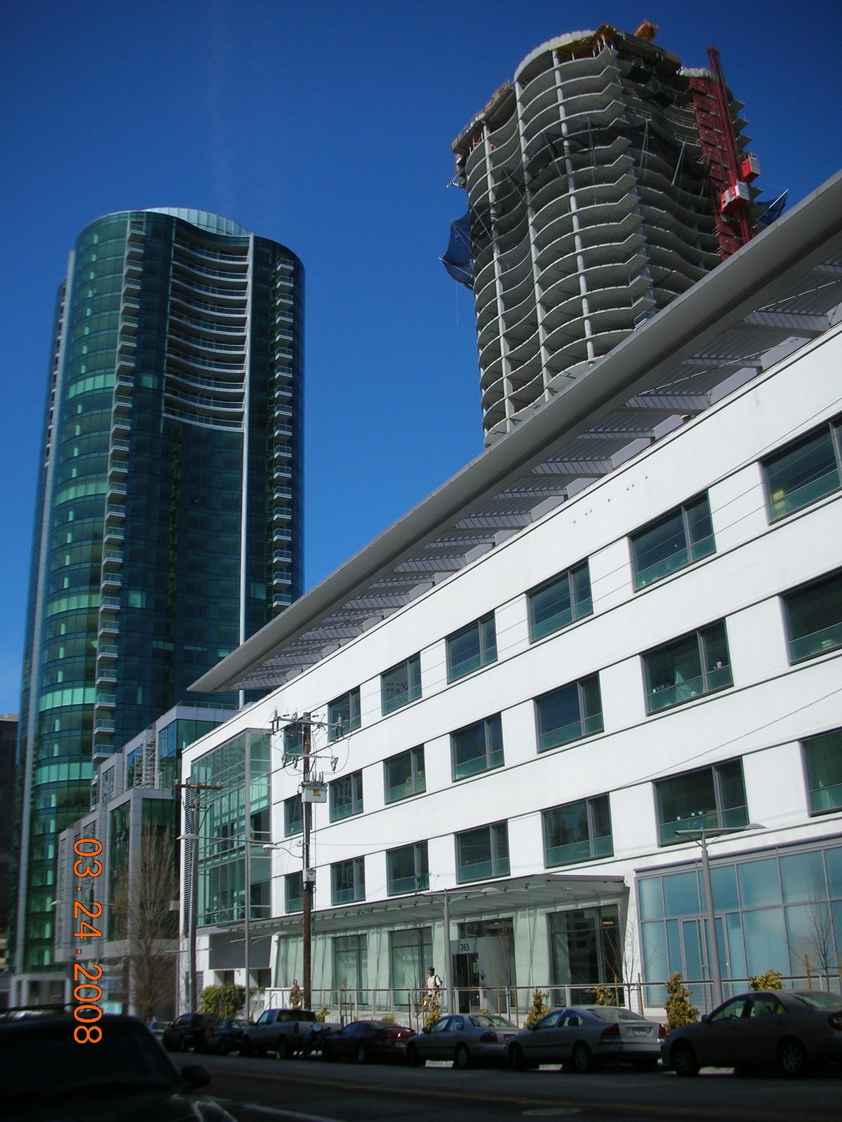 The Infinity complex at 300 Spear Street in San Francisco, showing completed Tower II on the left and under construction Tower I on the right, viewed from the east