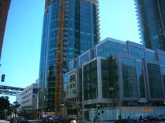 The Infinity 300 Spear Street complex low angle view showing Spear Street midrise center completed tower II right under construction tower I left center