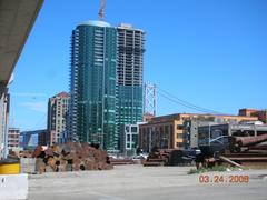 The Infinity complex at 300 Spear Street with completed tower II, tower I under construction, and San Francisco-Oakland Bay Bridge