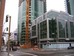 The Infinity Complex at 300 Spear Street on a stormy day with completed Tower II and Spear Street midrise on the right and under construction Tower I on left center