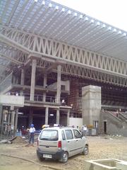 Exterior view of Tyagaraj Stadium in Delhi with modern architecture and green surroundings