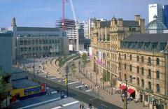 Manchester Exchange Square with tram and city buildings
