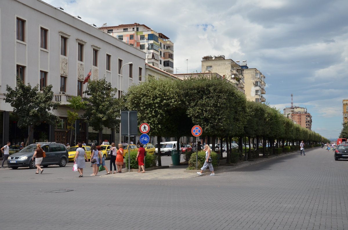 A panoramic view of Tirana cityscape with colorful buildings under a clear sky in July 2017