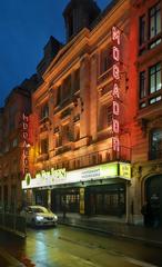 Théâtre Mogador in Paris at night with illuminated marquee lights