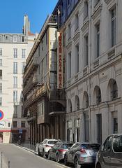 Front view of Théâtre du Palais-Royal in Paris with ornate architecture and clear sky