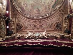 Ceiling view of Théâtre du Palais-Royal in Paris with ornate architecture and lighting
