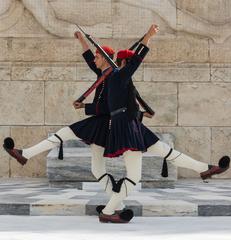 Two Evzones of the Greek Army crossing in front of the Tomb of the Unknown Soldier in Athens, Greece