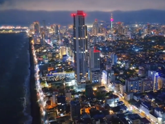 Colombo city skyline at night with illuminated buildings and dark sky