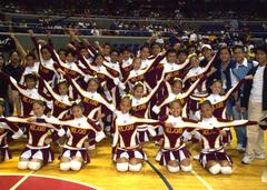 Manuel L. Quezon University cheering squad performing with pom-poms at an event