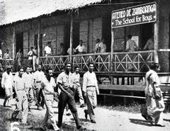 Ateneo de Zamboanga students leaving nipa-sawali classrooms during recess