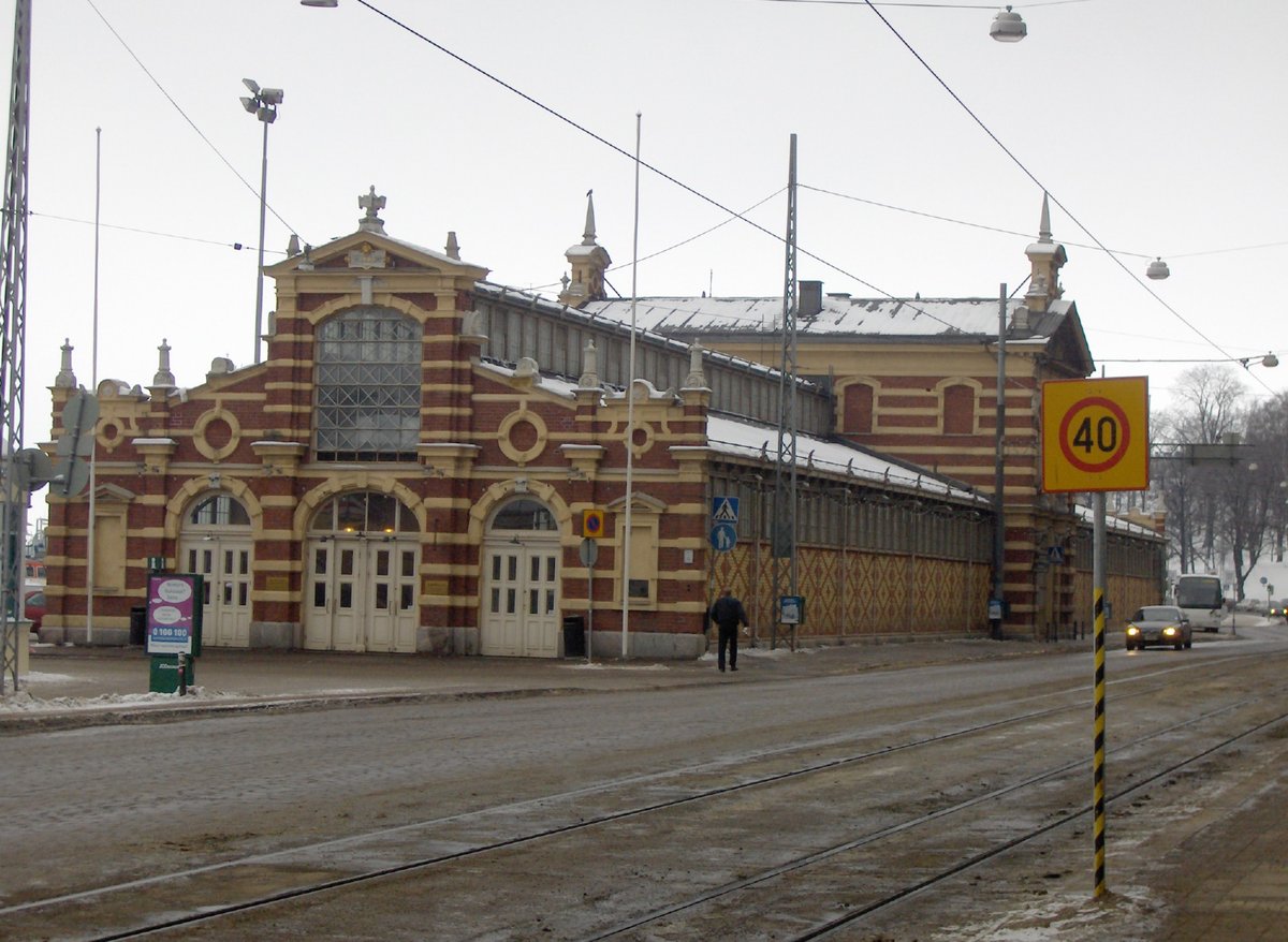 Interior view of Old Market Hall in Helsinki with wooden beams and food stalls