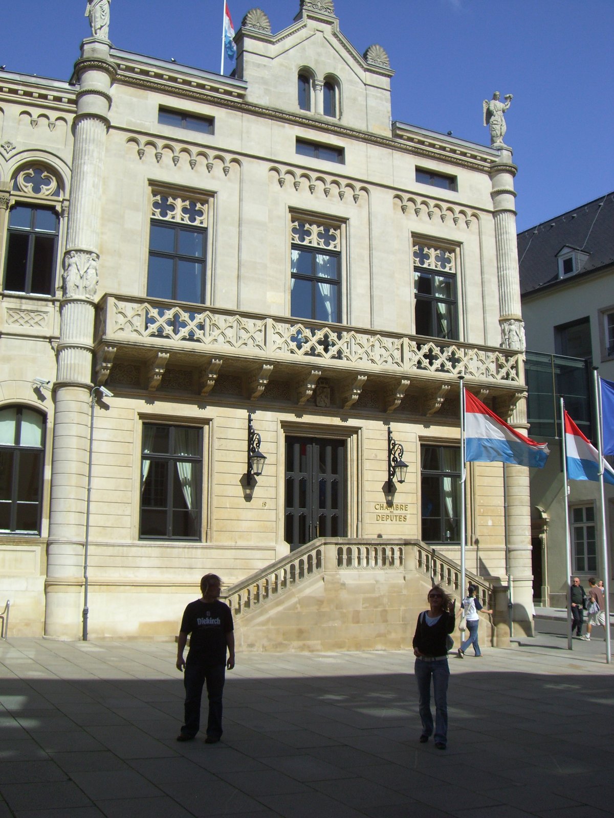 Luxembourgish Parliament chamber in Luxembourg City with rows of wooden seats and a large dome ceiling