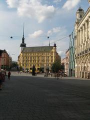 Main square Namesti svobody in Brno with historic buildings and fountain under a clear blue sky