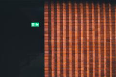 Exit sign next to brick wall at Whitworth Art Gallery Manchester