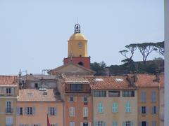 Saint-Tropez harbor with yachts and colorful buildings on a sunny day