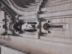 Statue on the left side of the portal of Église Saint-Baudile in Nîmes