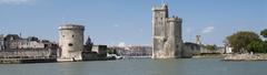Entrance to the port of La Rochelle in France with boats and historic buildings