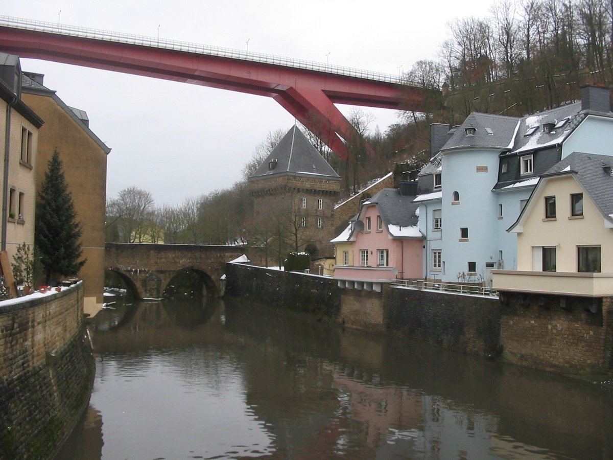 Alzette River flowing through Pfaffenthal in Luxembourg City with the Red Bridge (Grand Duchess Charlotte Bridge) above