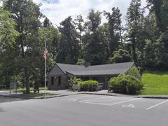 Humpback Rocks Visitor Center at Blue Ridge Parkway in Virginia surrounded by lush green trees and clear blue sky