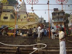 Entry to the holy Dasaswamedh Ghat bathing area at sunrise with pilgrims and boats
