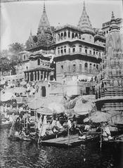 Bathing Ghat in Benares India with people gathered by the river