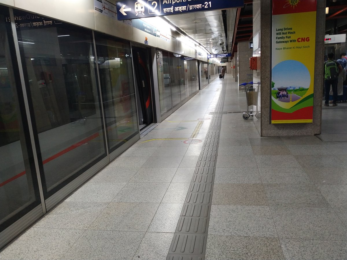 New Delhi Metro Station platform with a metro train at Delhi Airport Metro line in New Delhi, India