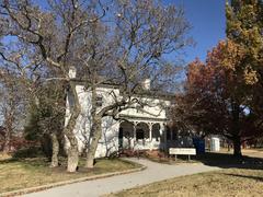 White House at Patterson Park, Baltimore, Maryland in autumn with bare trees and a cloudy sky