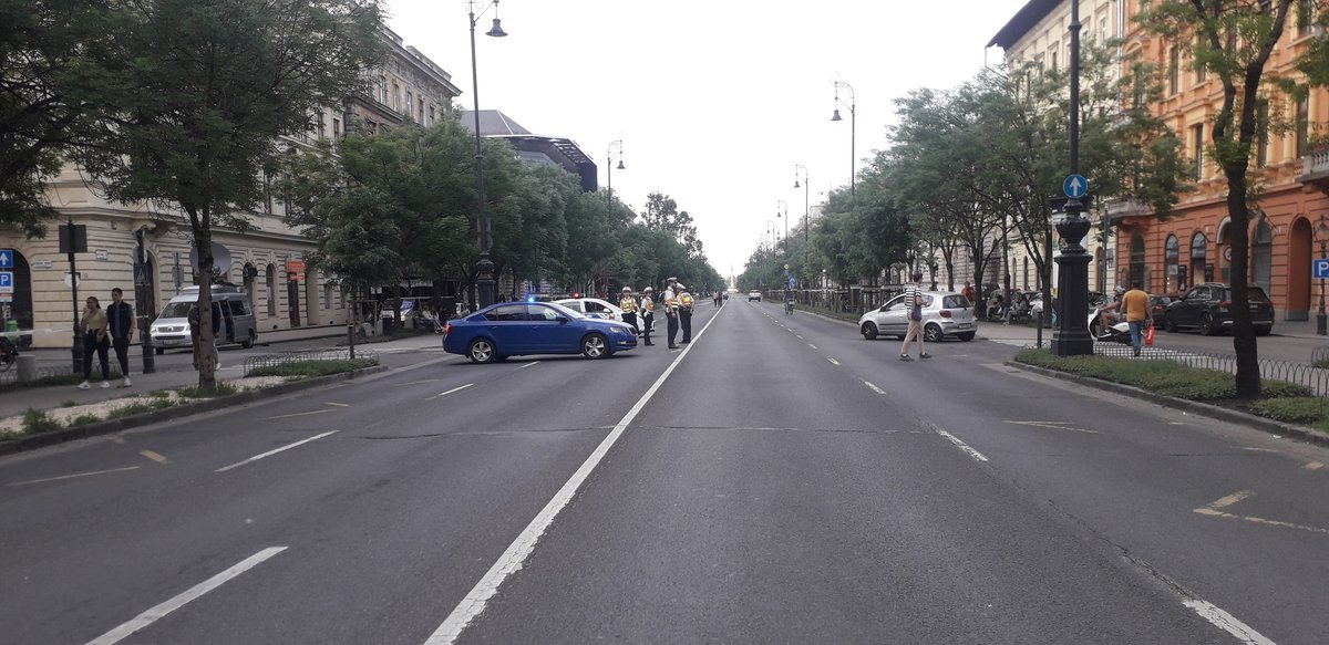 Aerial view of Andrássy út, a historic boulevard in Budapest with tree-lined sidewalks, tram tracks, and classic architecture