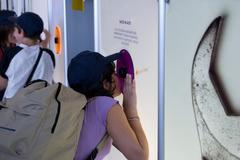 Child observing an exhibit at the Science Centre in Città della Scienza, Naples